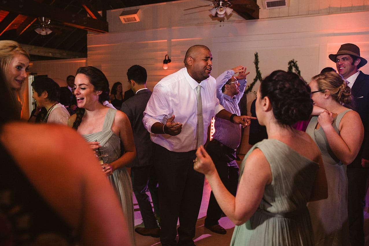 A documentary photograph of guests dancing during a plimoth plantation wedding in plymouth, massachusetts