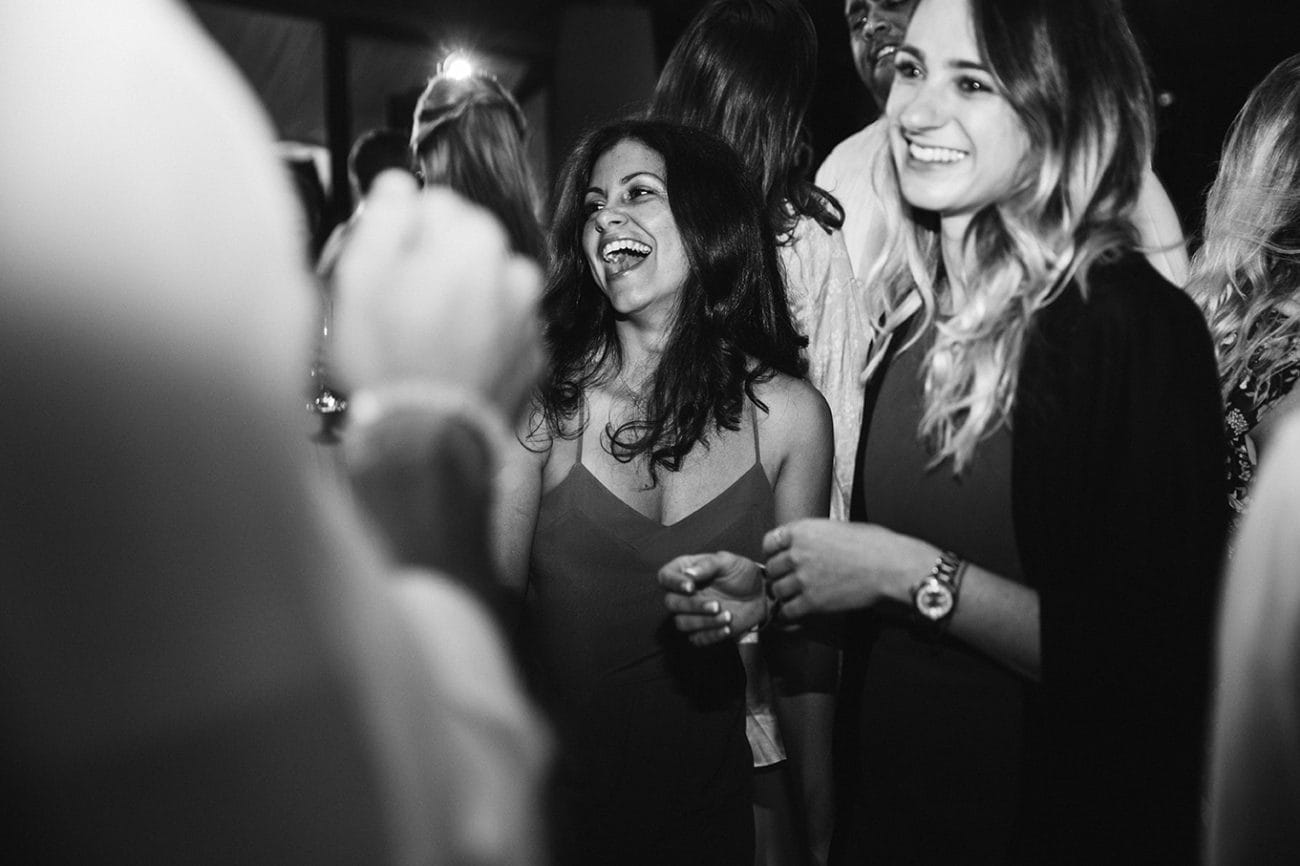 A documentary photograph of guests talking and dancing during a plimoth plantation wedding in plymouth, massachusetts