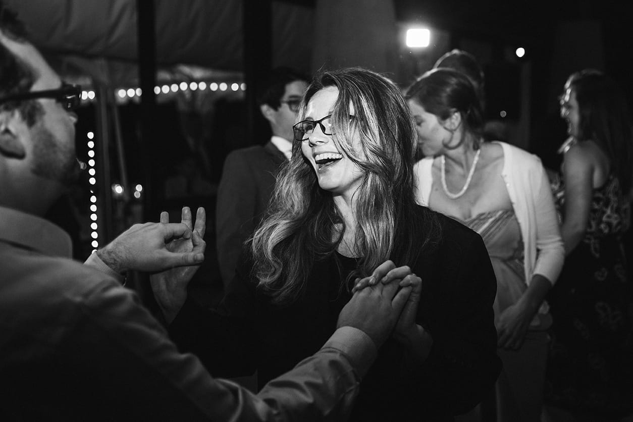 A documentary photograph of guests dancing during a plimoth plantation wedding in plymouth, massachusetts