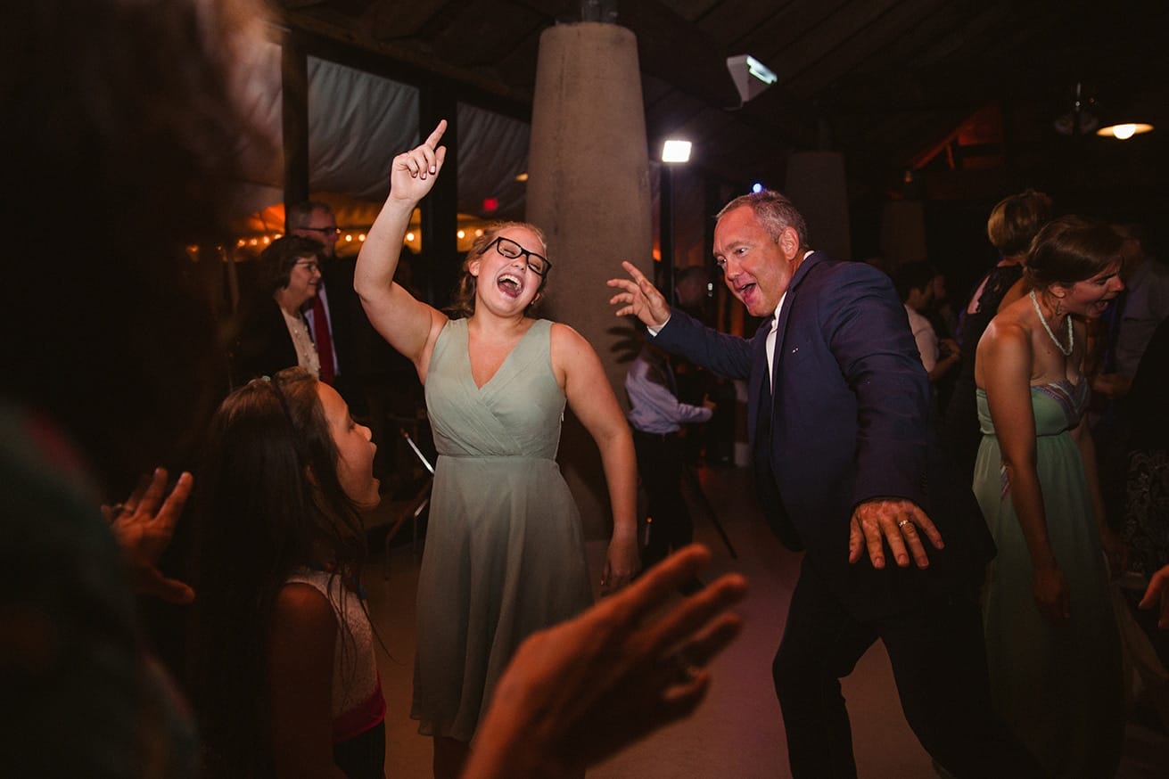 A documentary photograph of guests dancing during a plimoth plantation wedding in plymouth, massachusetts