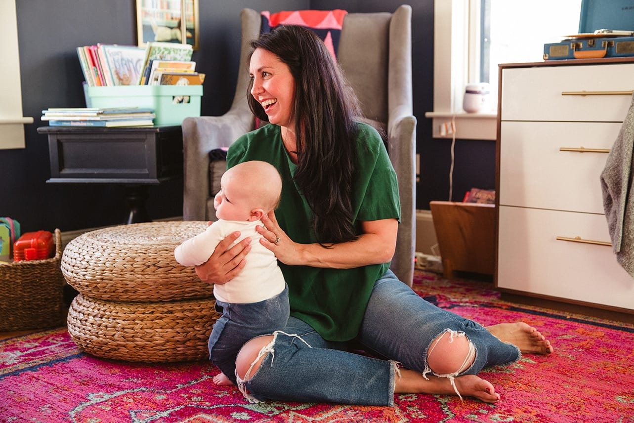 A documentary photograph of a mom holding her baby boy during an in home family lifestyle session in Boston, Massachusetts