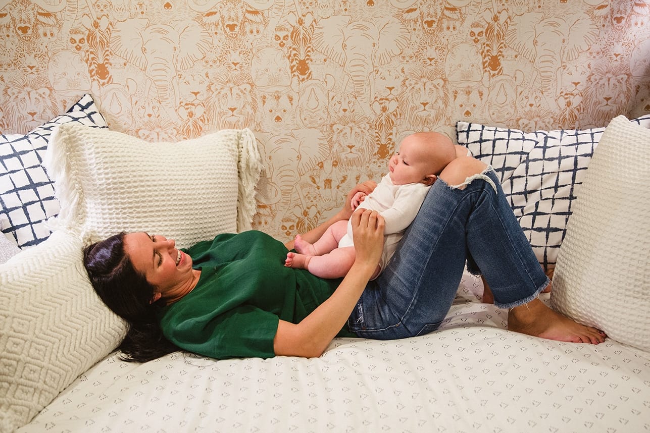 A documentary photograph of mom looking at her baby boy during an in home family lifestyle session in Boston, Massachusetts