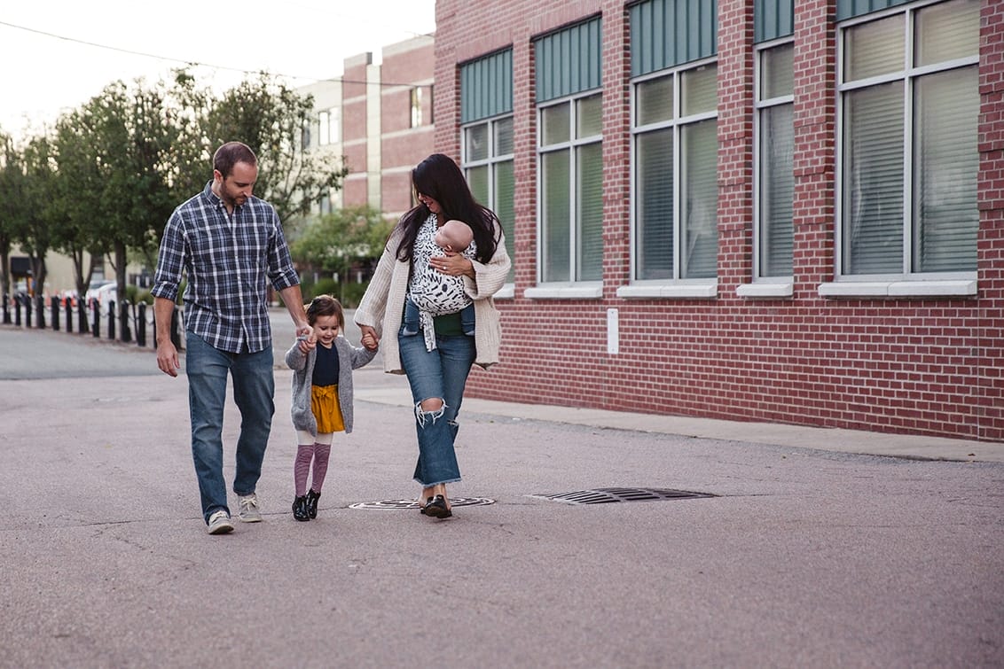 A documentary photograph of a family walking to the playground during their in home family lifestyle session in Boston, Massachusetts