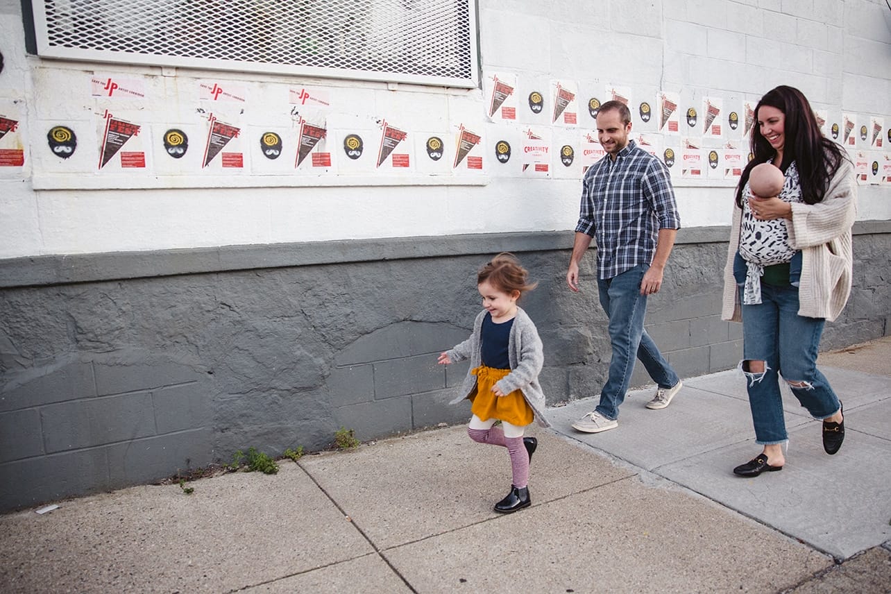 A documentary photograph of a family walking to the playground during their in home family lifestyle session in Boston, Massachusetts