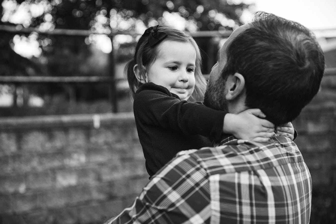 A documentary photograph of a father holding his daughter during a family lifestyle session in Boston, Massachusetts
