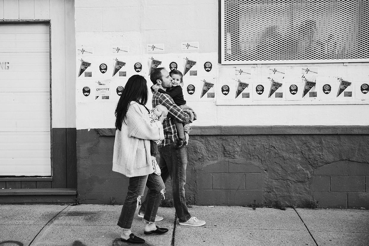 A documentary photograph of a family walking home from the playground during a family lifestyle session in Boston, Massachusetts