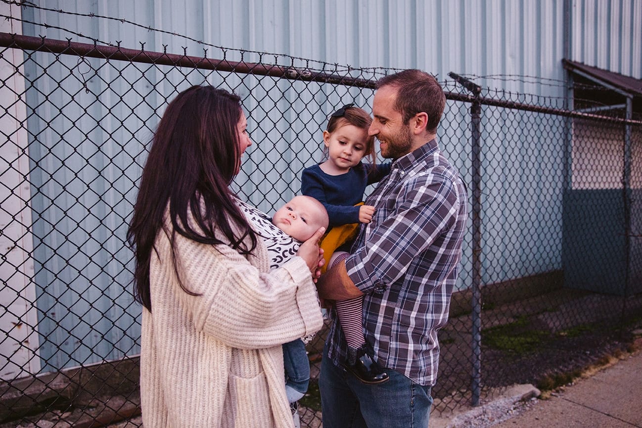 A documentary photograph of a family laughing together while they walk home from the playground during their family lifestyle session in Boston, Massachusetts