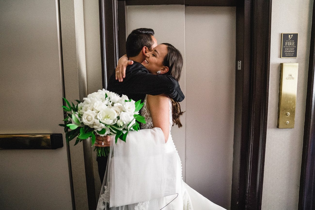 A documentary photograph of a bride hugging her brother before her Fairmont Copley Wedding in Boston