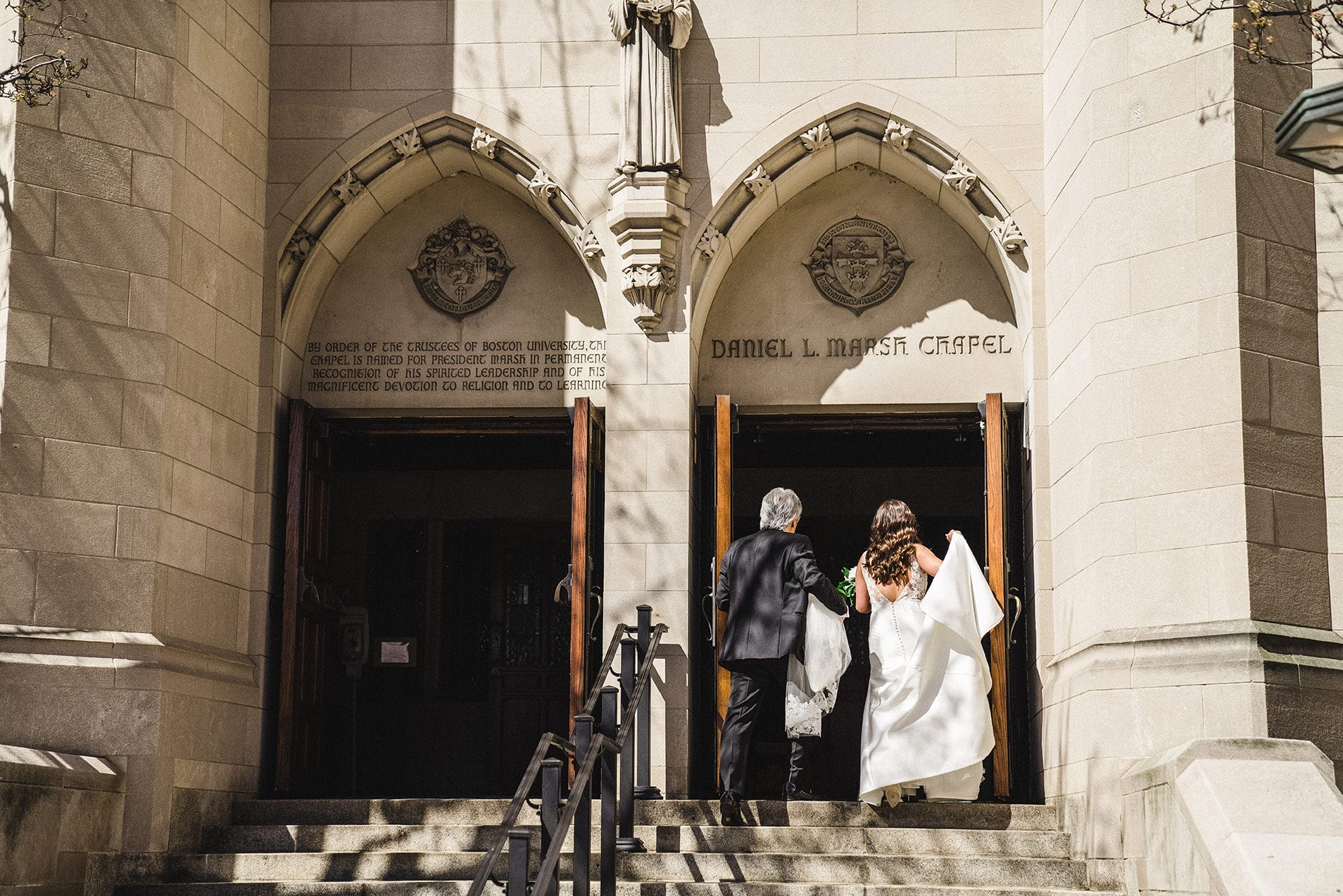 A documentary photograph of a bride walking into the chapel with her father during her Fairmont Copley Wedding in Boston
