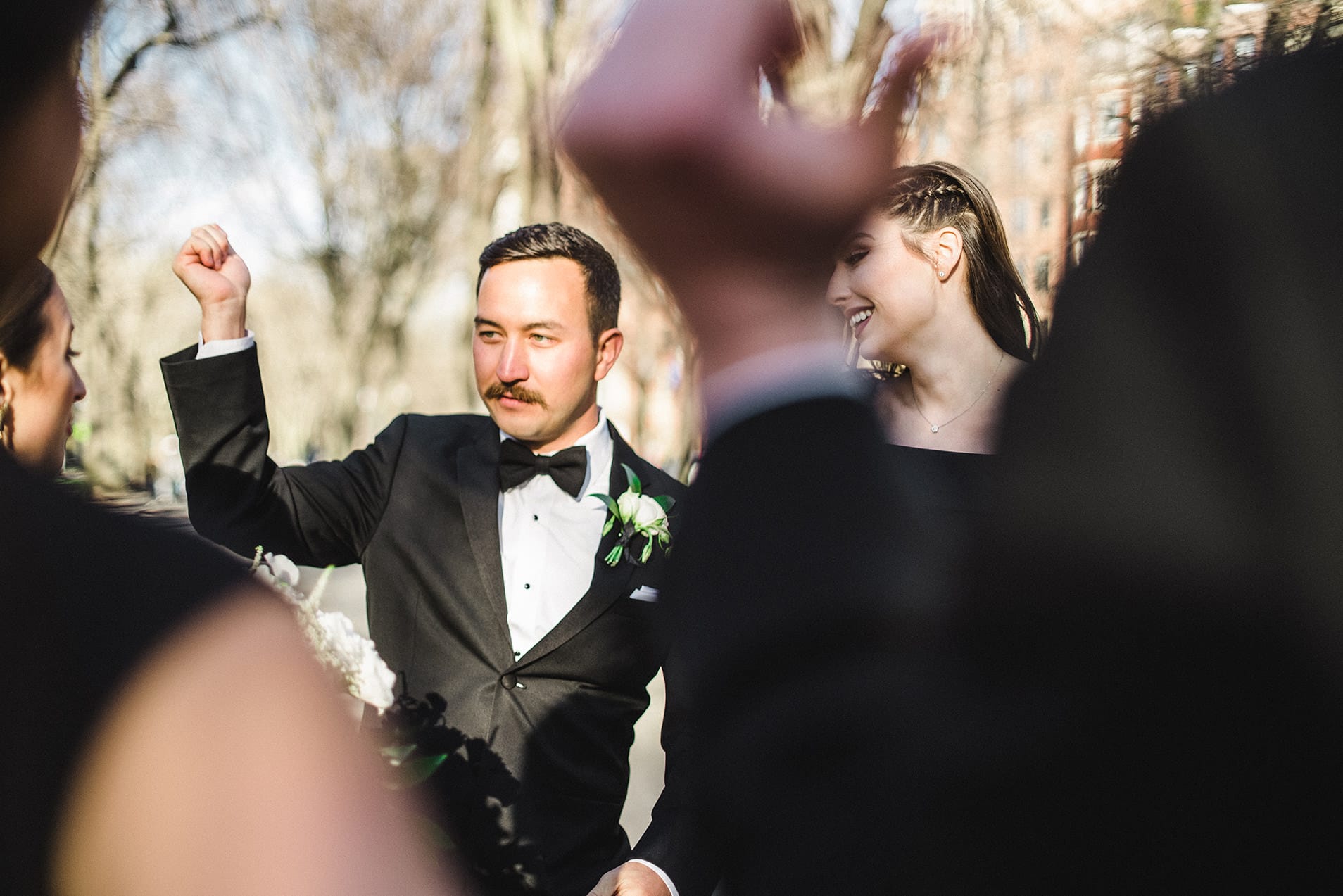 A documentary photograph of the wedding party celebrating after the ceremony at marsh chapel