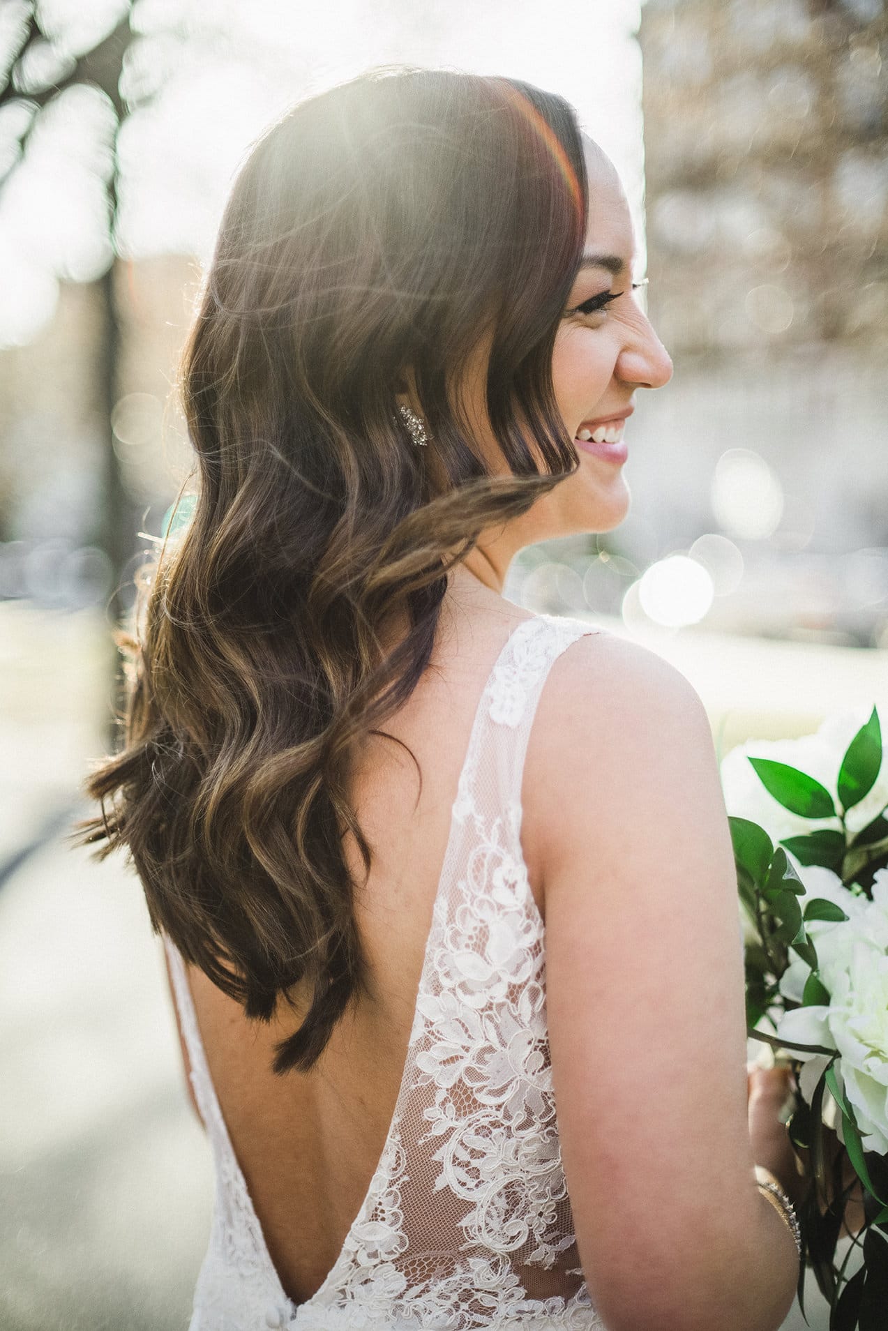 A candid portrait of a bride on commonwealth mall during her fairmont copley wedding