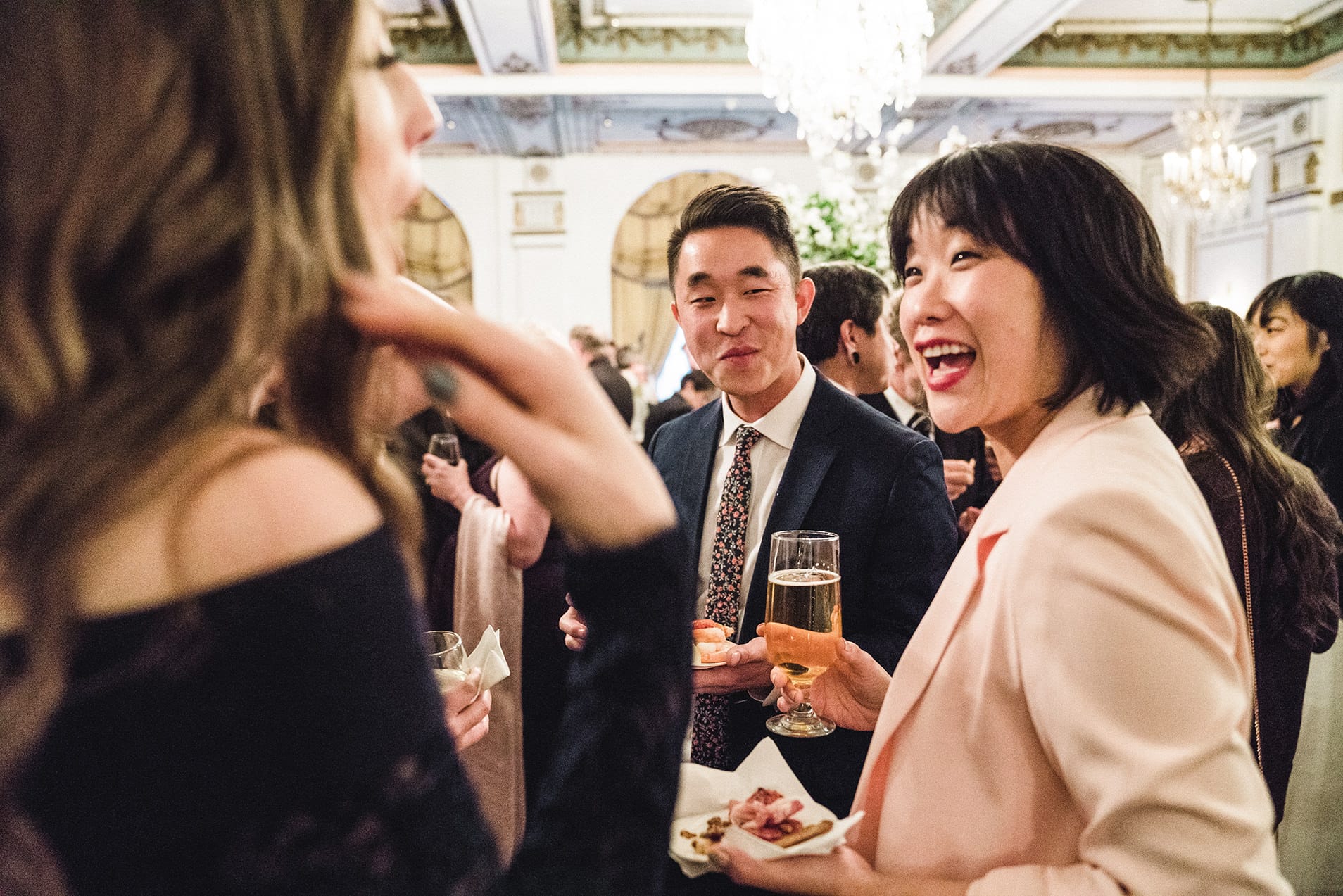 A documentary photograph of guests talking during cocktail hour of a fairmont copley wedding