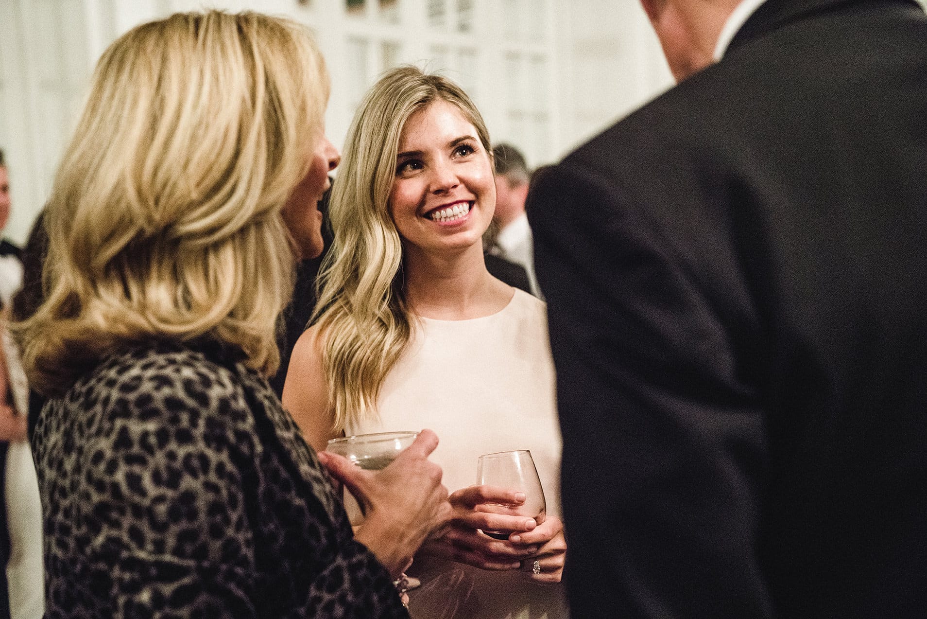 A documentary photograph of guests talking during cocktail hour of a fairmont copley wedding