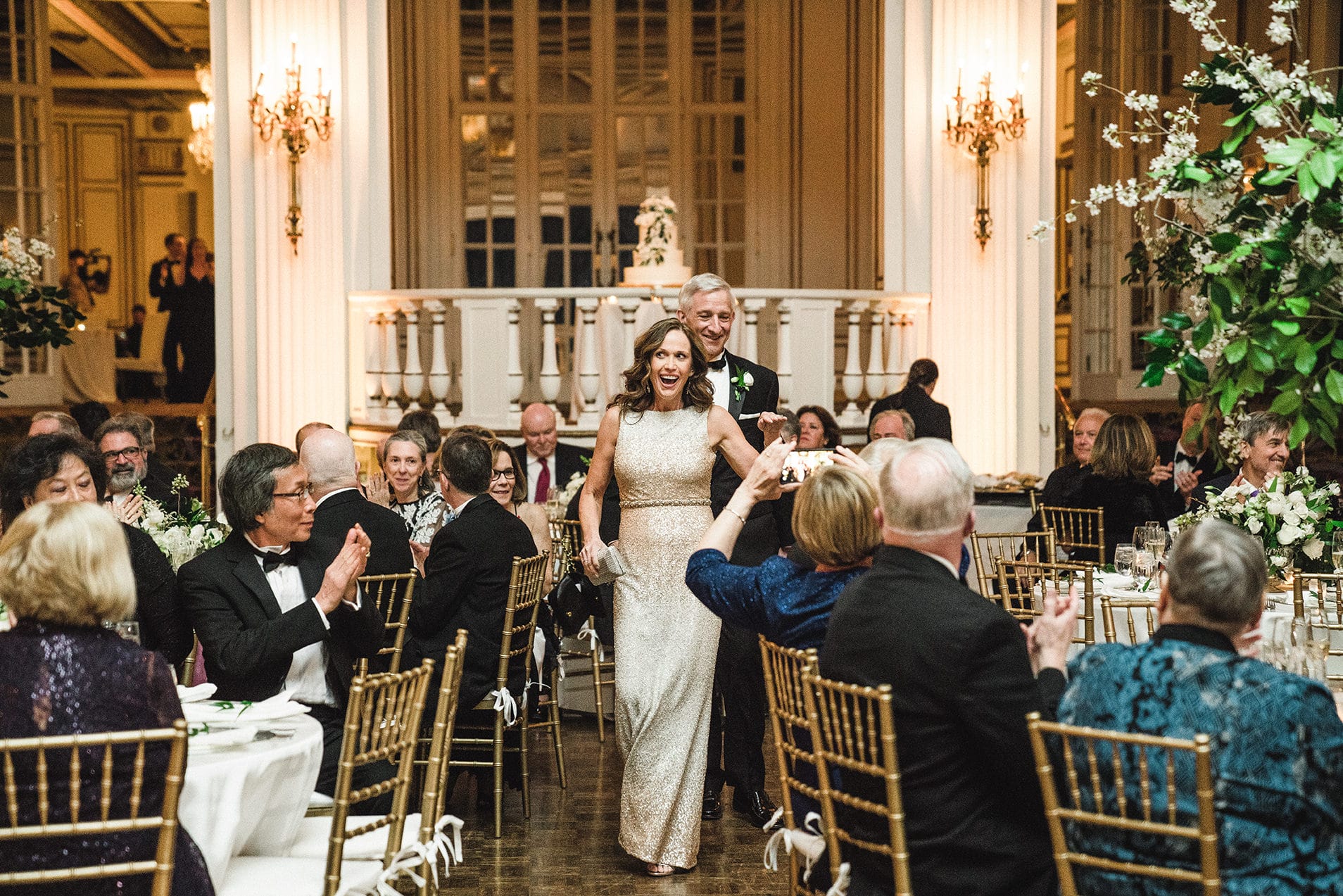 A documentary photograph of the grooms parents entering the reception of a fairmont copley wedding