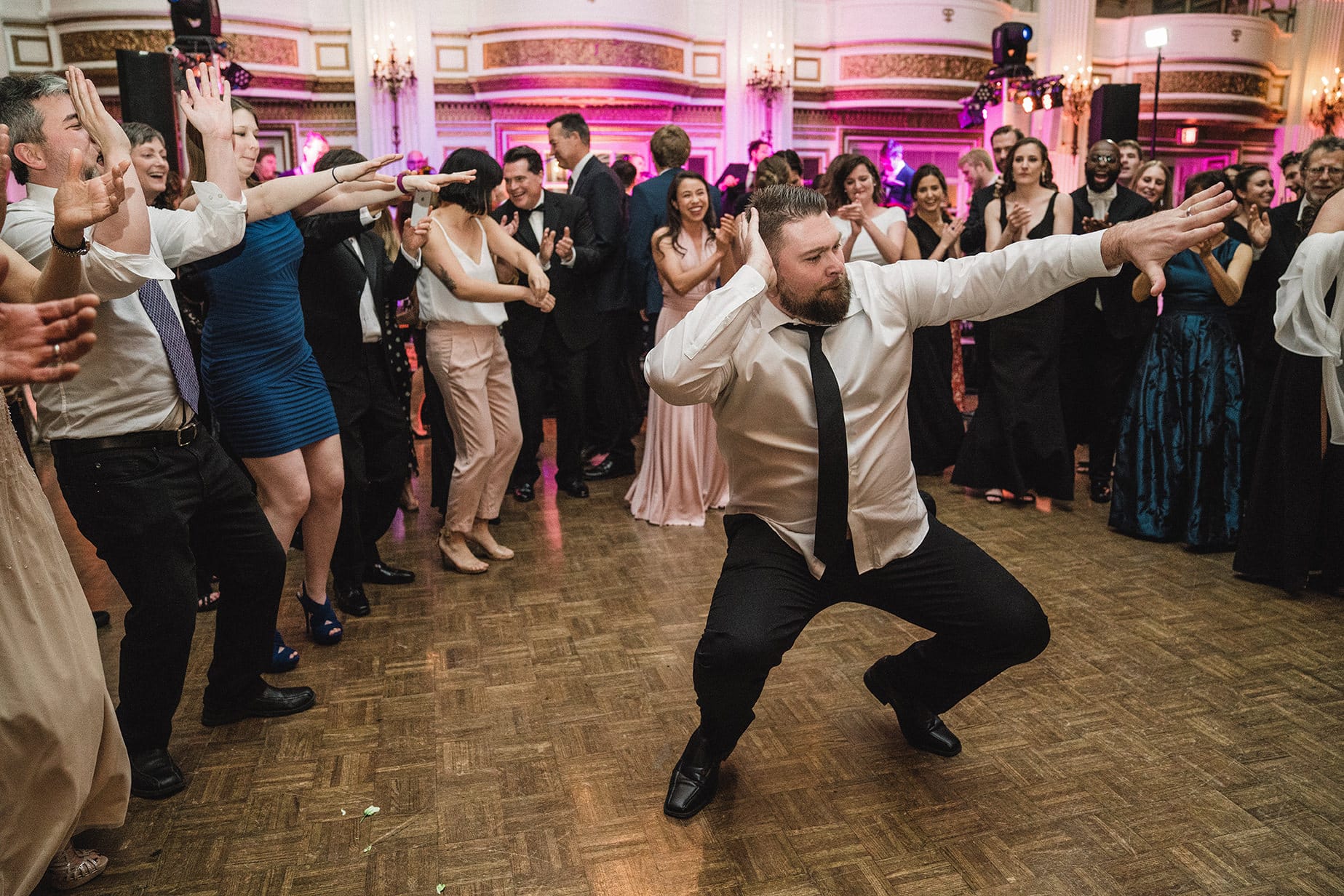 A documentary photograph of guests dancing at a fairmont copley wedding