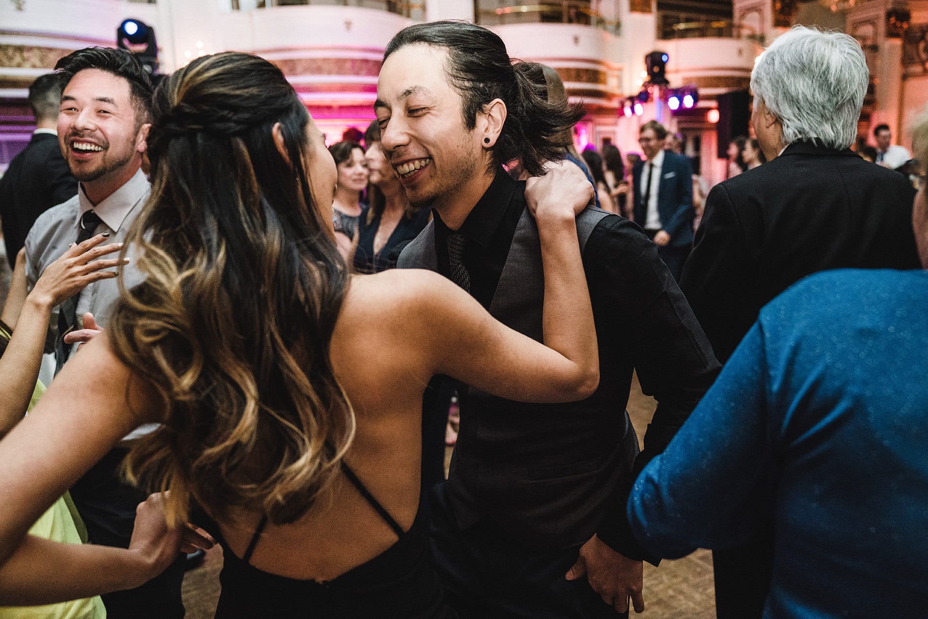A documentary photograph of guests dancing at a fairmont copley wedding