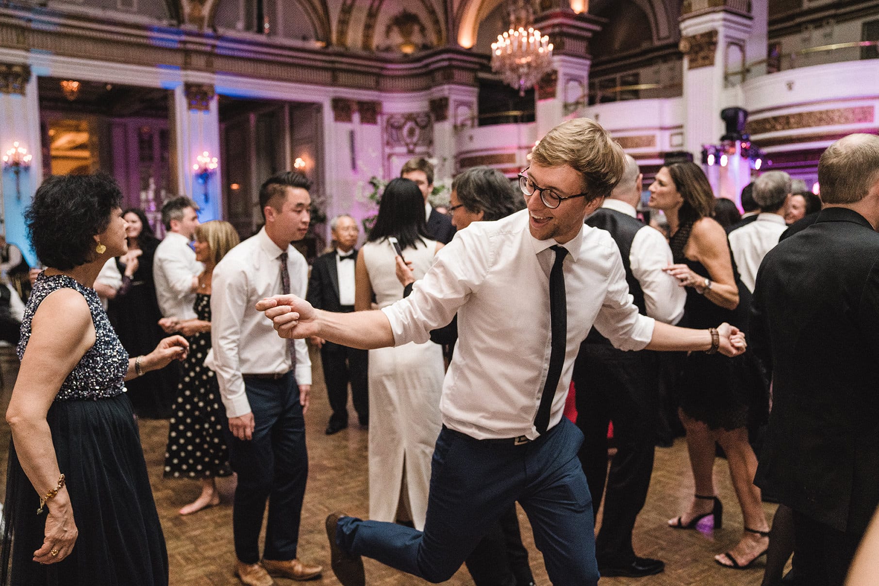 A documentary photograph of guests dancing at a fairmont copley wedding