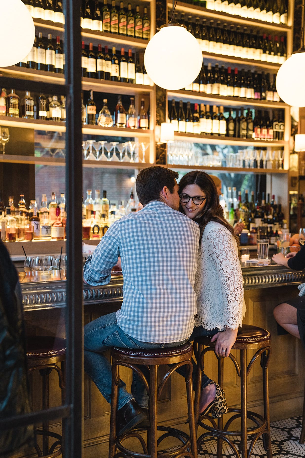 A documentary photograph of a couple talking at Aquitaine during their South End Engagement Session