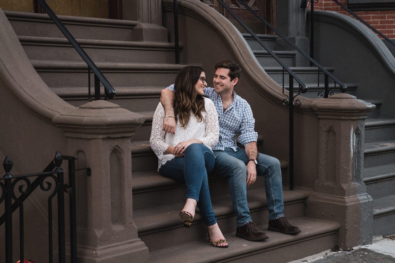 A documentary photograph of a couple talking and laughing during their South End Boston Engagement Session