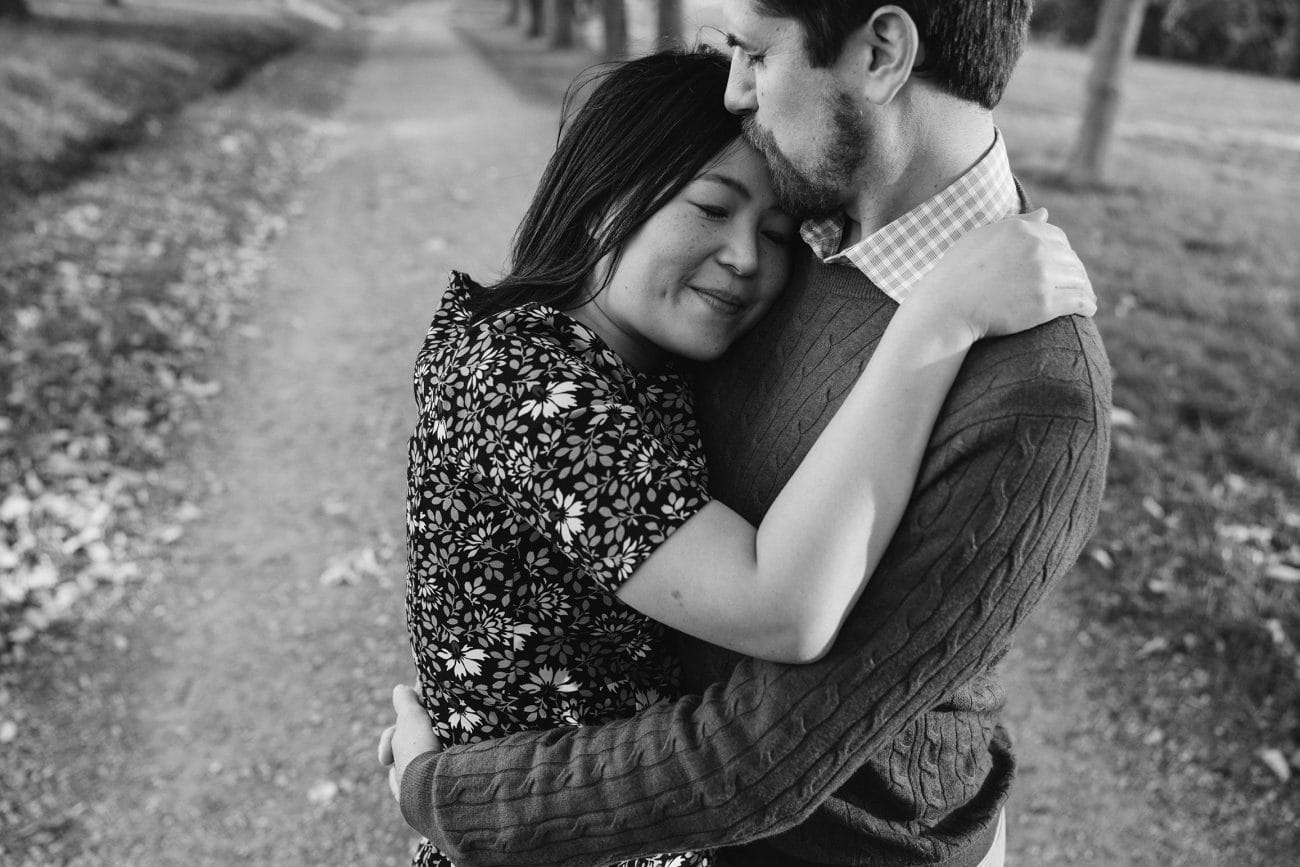 A candid portrait of a couple hugging and kissing during their boston engagement session at the worlds end