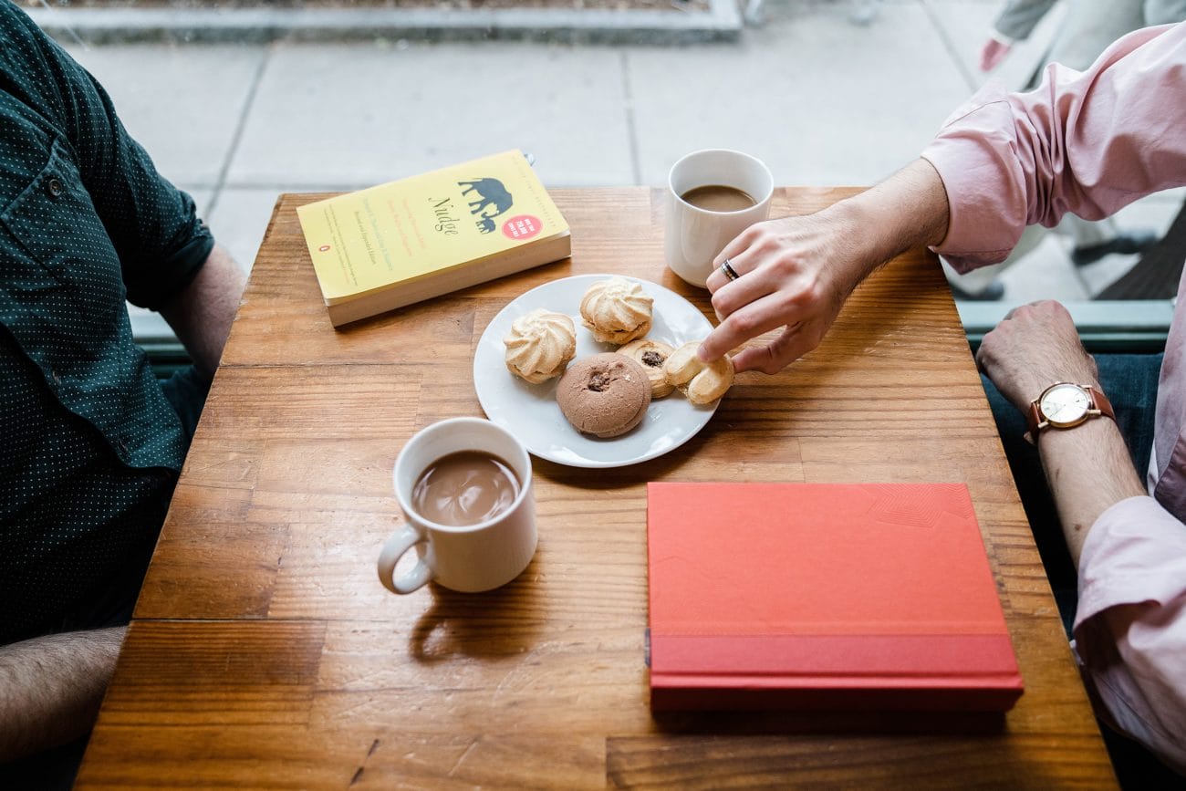 A documentary photograph of a couple having coffee during their boston engagement session