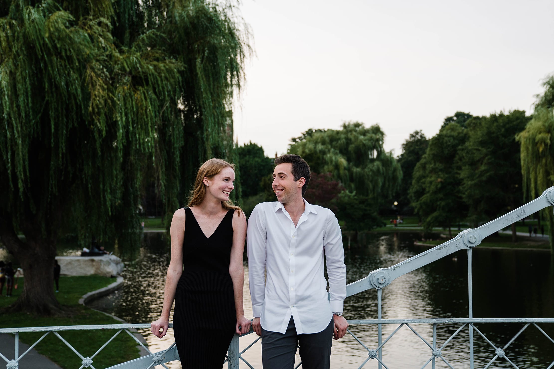 A documentary portrait of a couple hanging out on the bridge at the boston public gardens during their boston engagement session