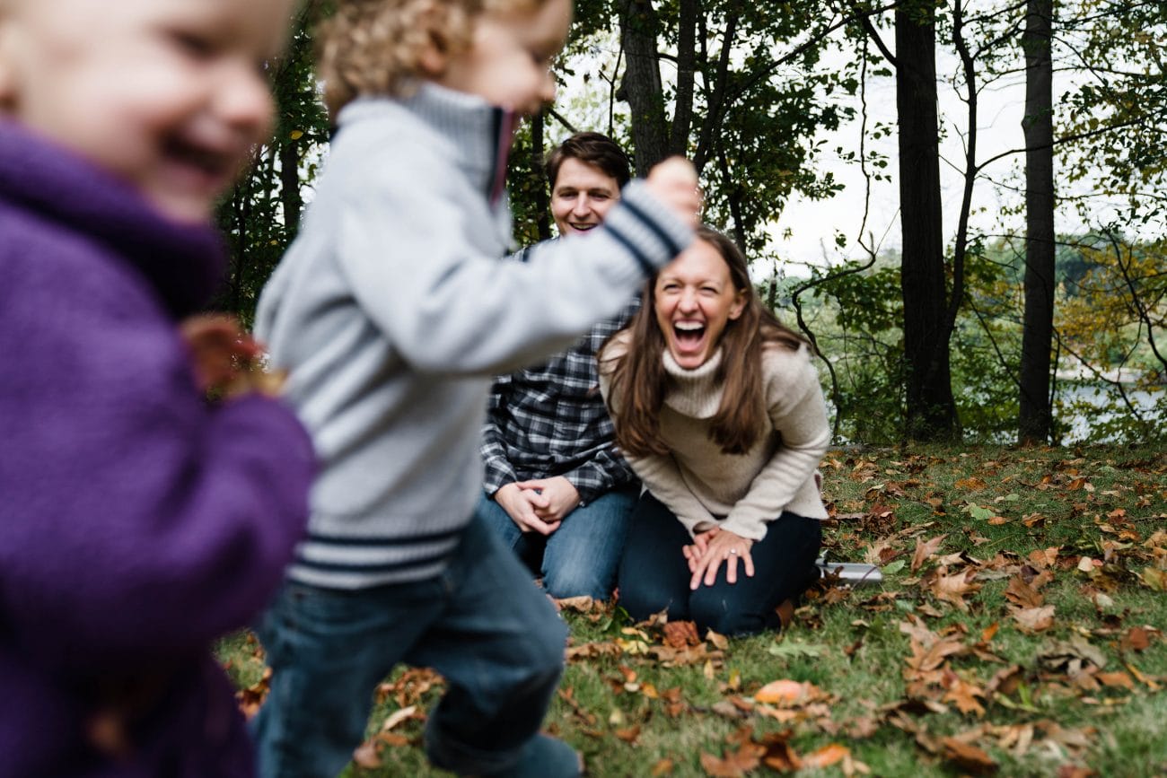 A best of boston family photograph of kids running by their parents during a Jamaica pond family session in Boston