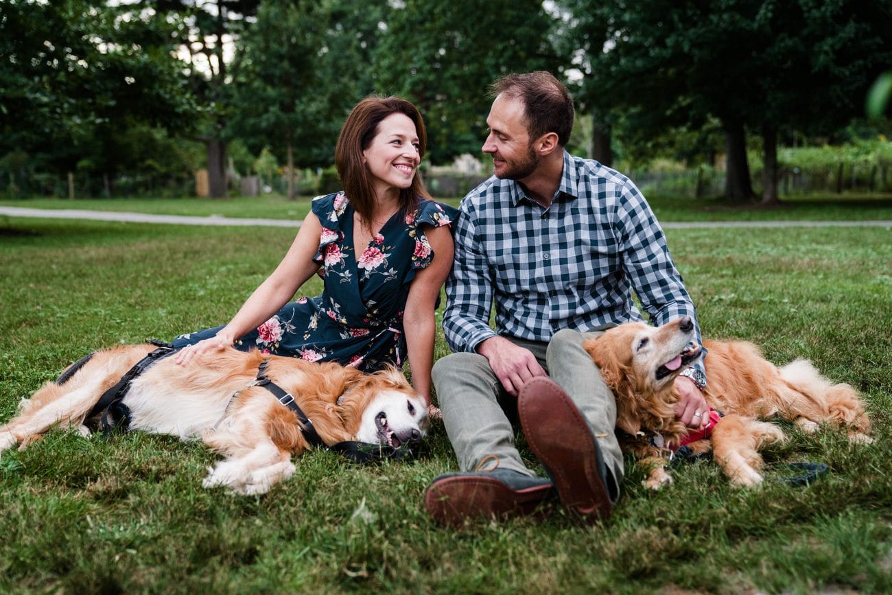 A documentary portrait of a couple with their dogs at back bay fens during their Boston engagement session