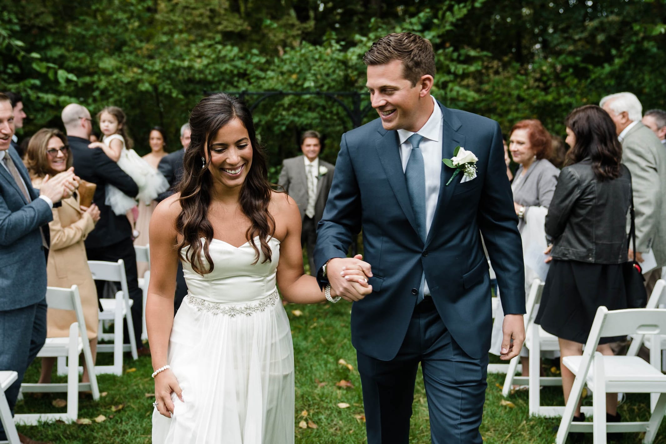A best of Boston photograph of a bride and groom walking down the aisle after getting married at the Inn at Hastings Park