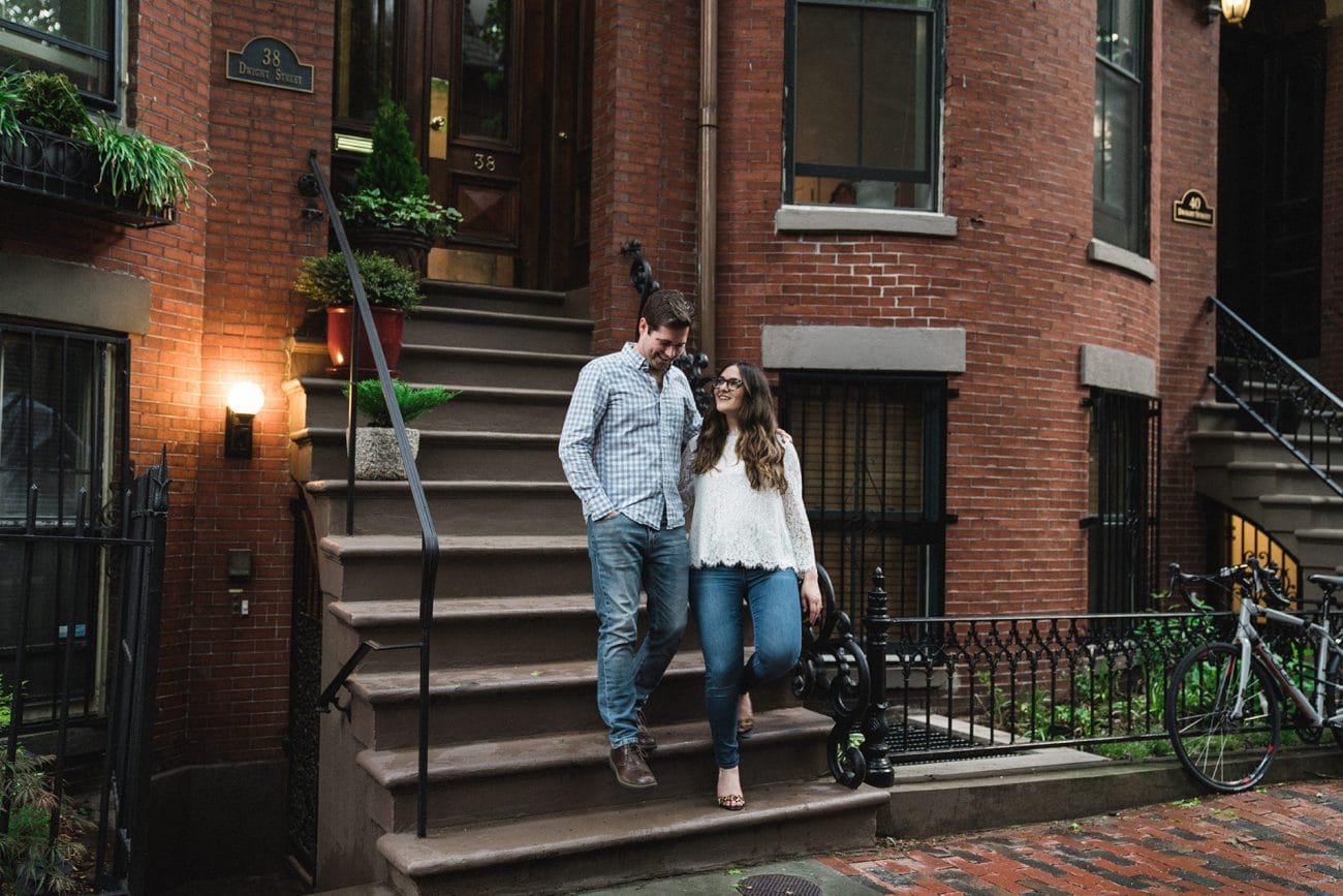 A documentary photograph of a couple leaving their home during their south end Boston engagement session