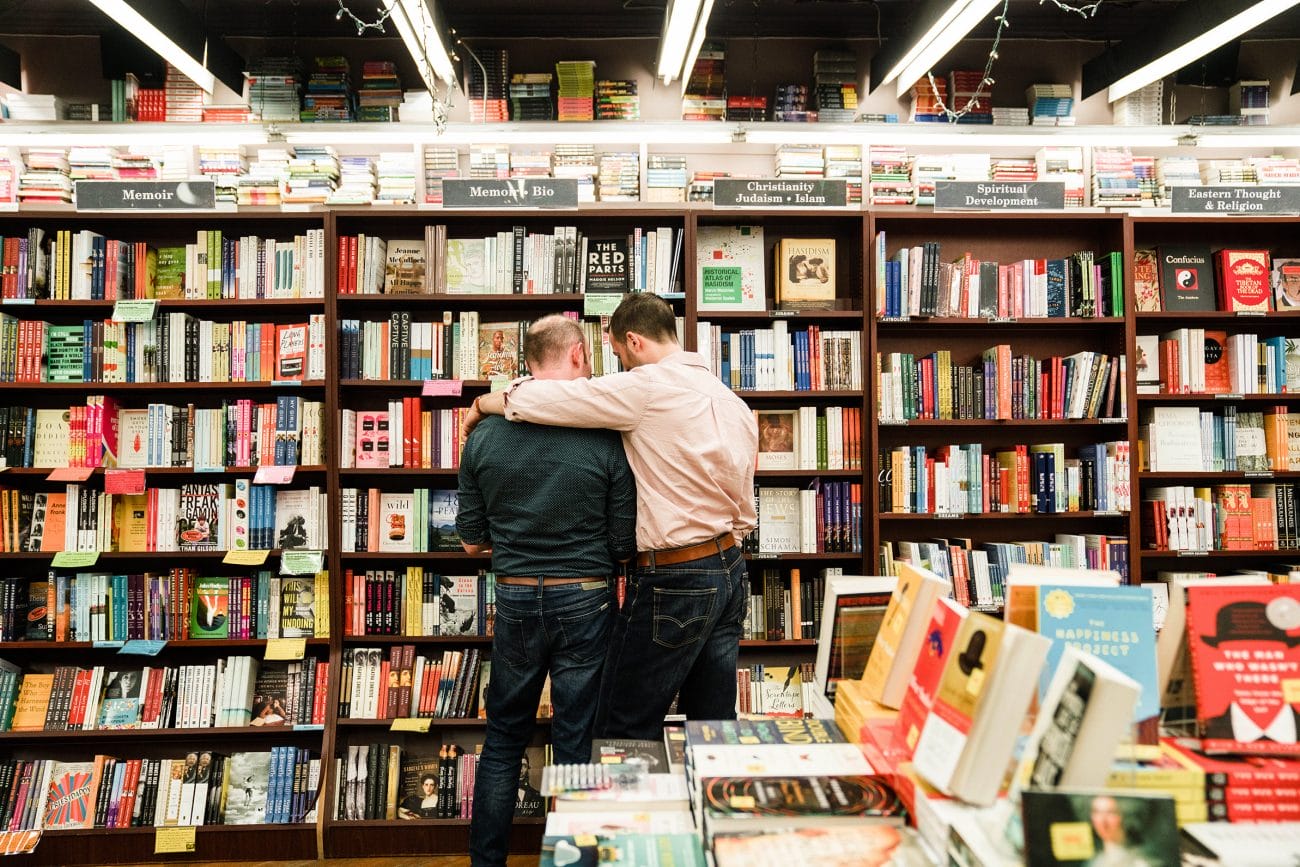 A documentary photograph of a couple looking at books together during their Boston engagement session