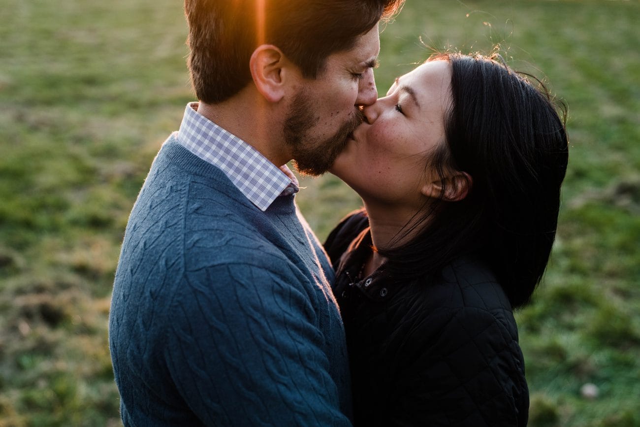 A natural and intimate portrait of a couple kissing during their Boston engagement session at the world's end