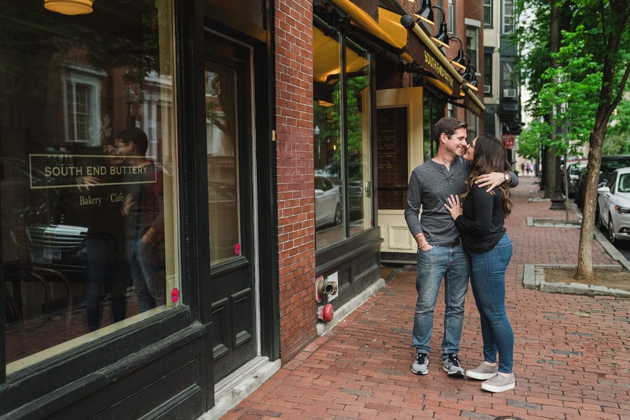 A documentary portrait of a couple kissing during their Boston South End engagement session