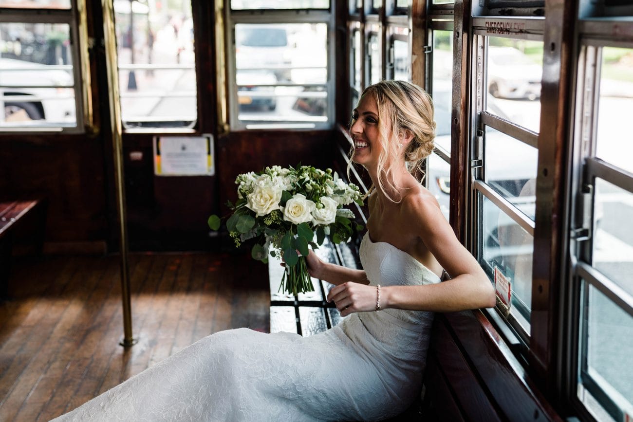 A best of Boston wedding photograph of a bride sitting on a trolley before her wedding ceremony during her State Room wedding
