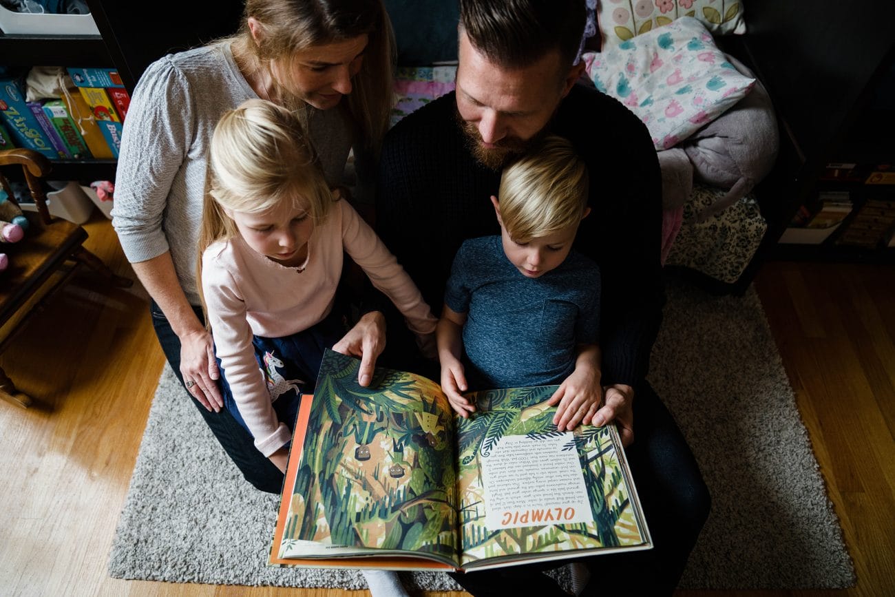 A best of Boston family photograph of a family reading a book during their in home family session in the South End of Boston