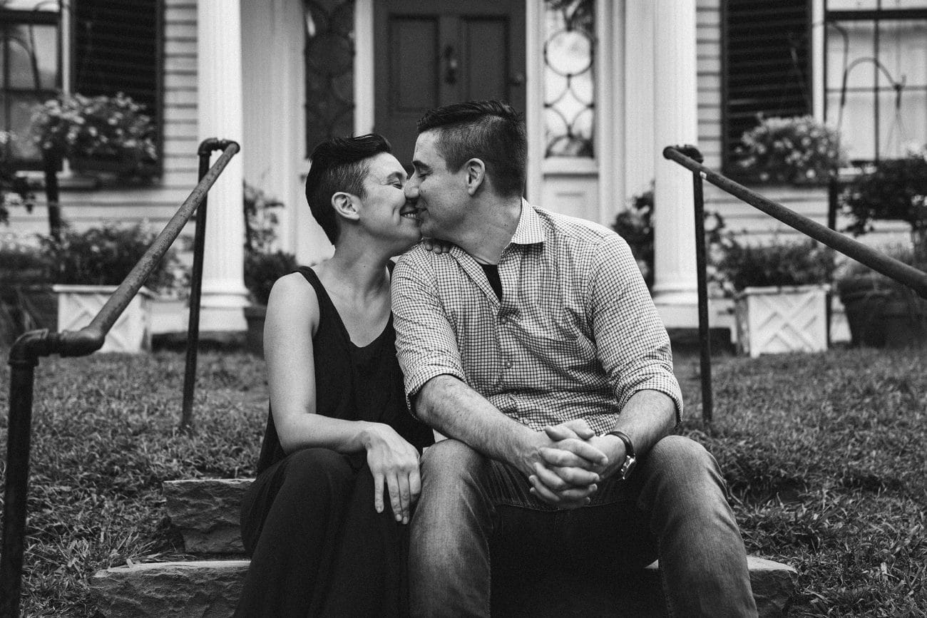 A best of Boston family photograph of parents giving each other a kiss during their in home family session in Boston