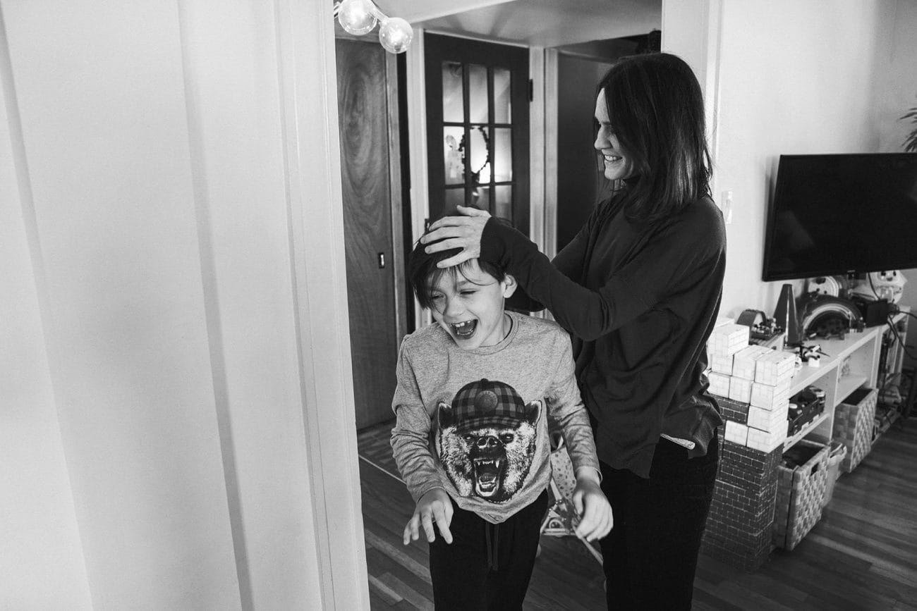 A best of Boston family photograph of a mom rubbing her son's head during an in home family session in Boston