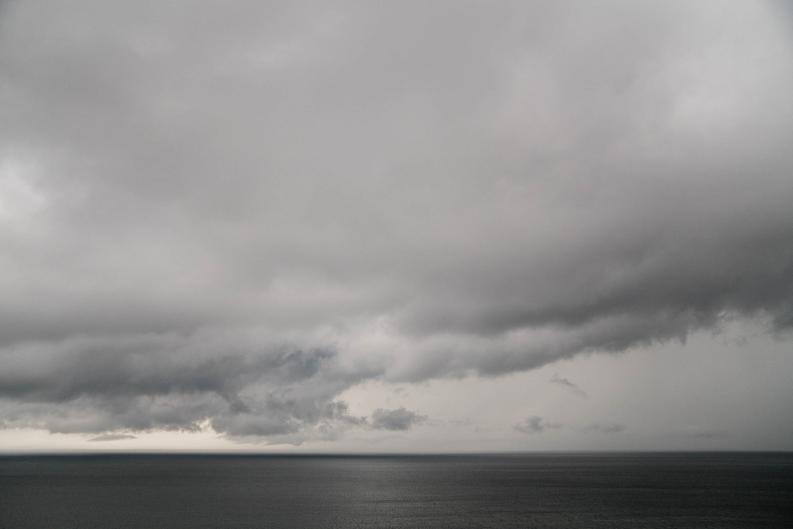 A best of Boston wedding photograph of storm coming in over the ocean during an wedding in Plymouth, MA