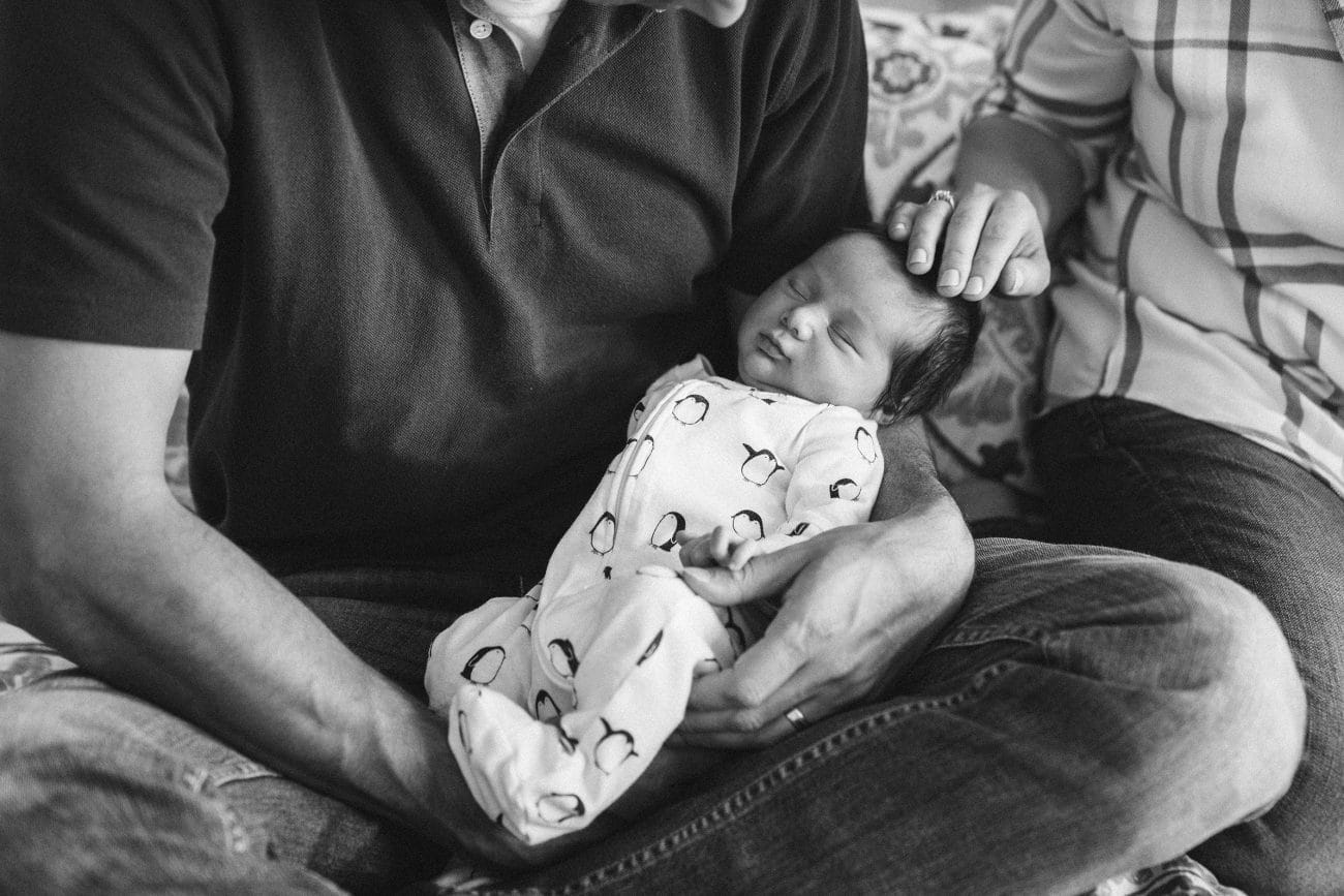 A best of Boston family photograph of parents holding their newborn son during an in home lifestyle newborn session in Boston