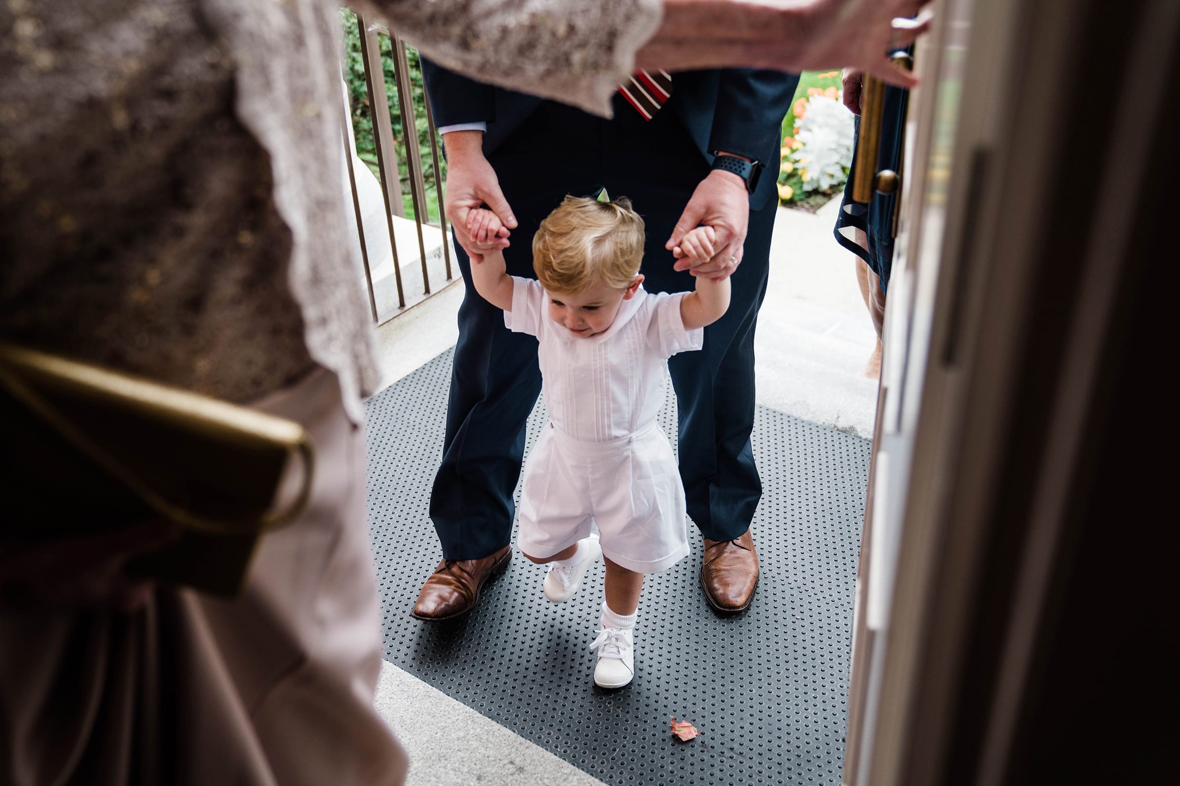 A best of Boston wedding photograph of a page boy walking into the church before a Boston wedding