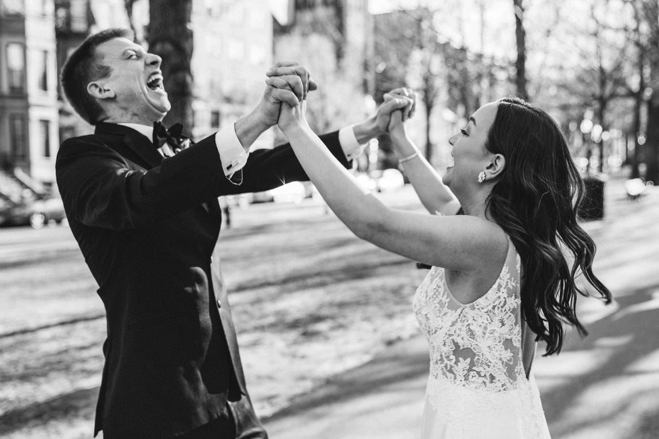 A best of Boston wedding photograph of a couple cheering after their wedding ceremony in Boston