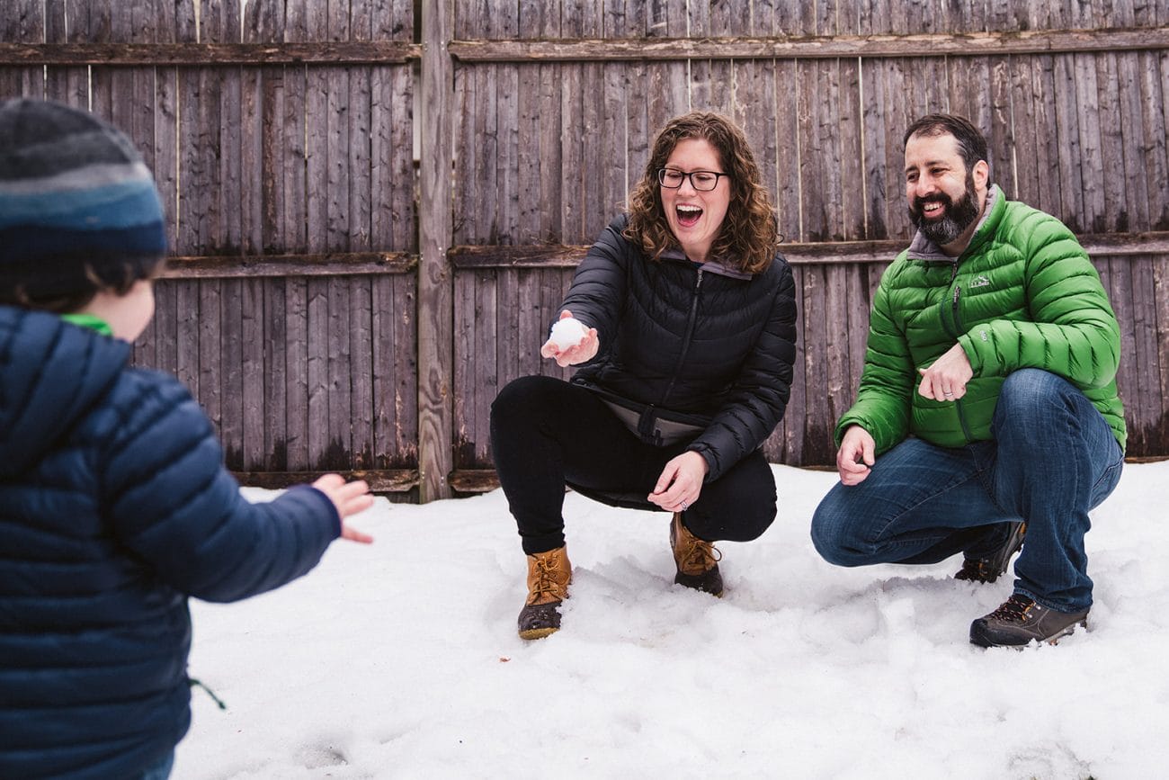 A best of Boston family photograph of family playing in the snow during an in home family session in Boston