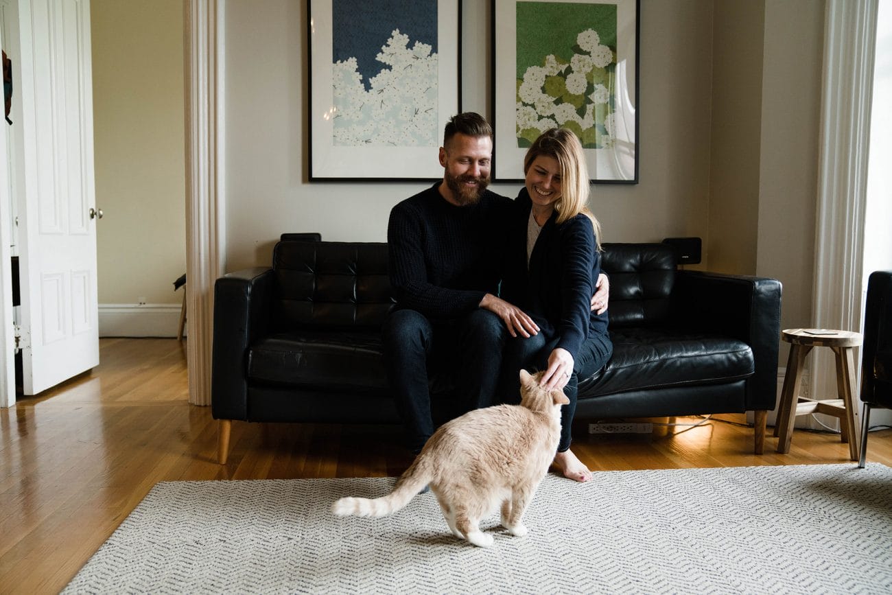 A best of Boston family photograph of a couple petting their cat during an in home family session in the South End of Boston