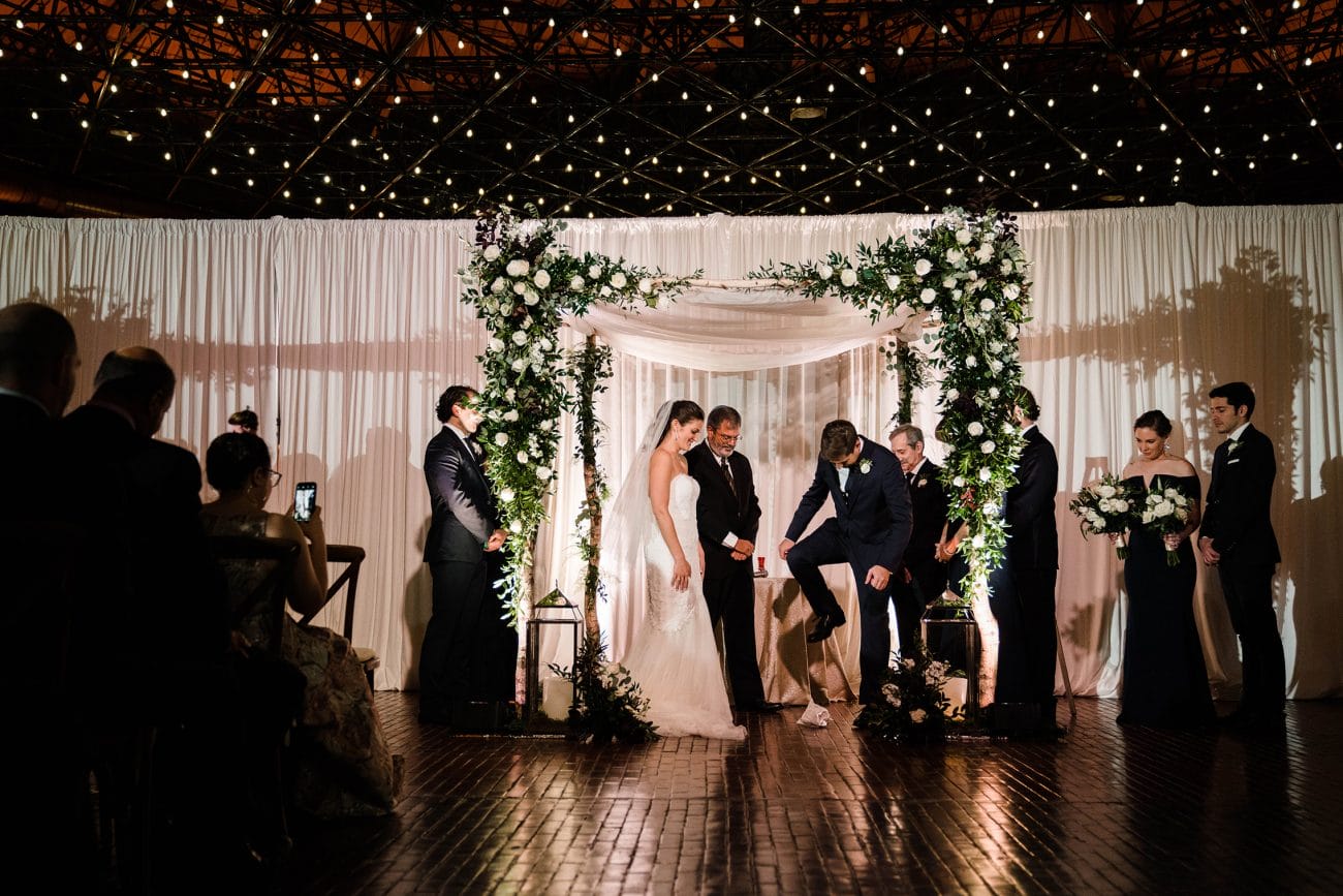 A best of Boston wedding photograph of couple breaking the glass during their Cyclorama wedding ceremony