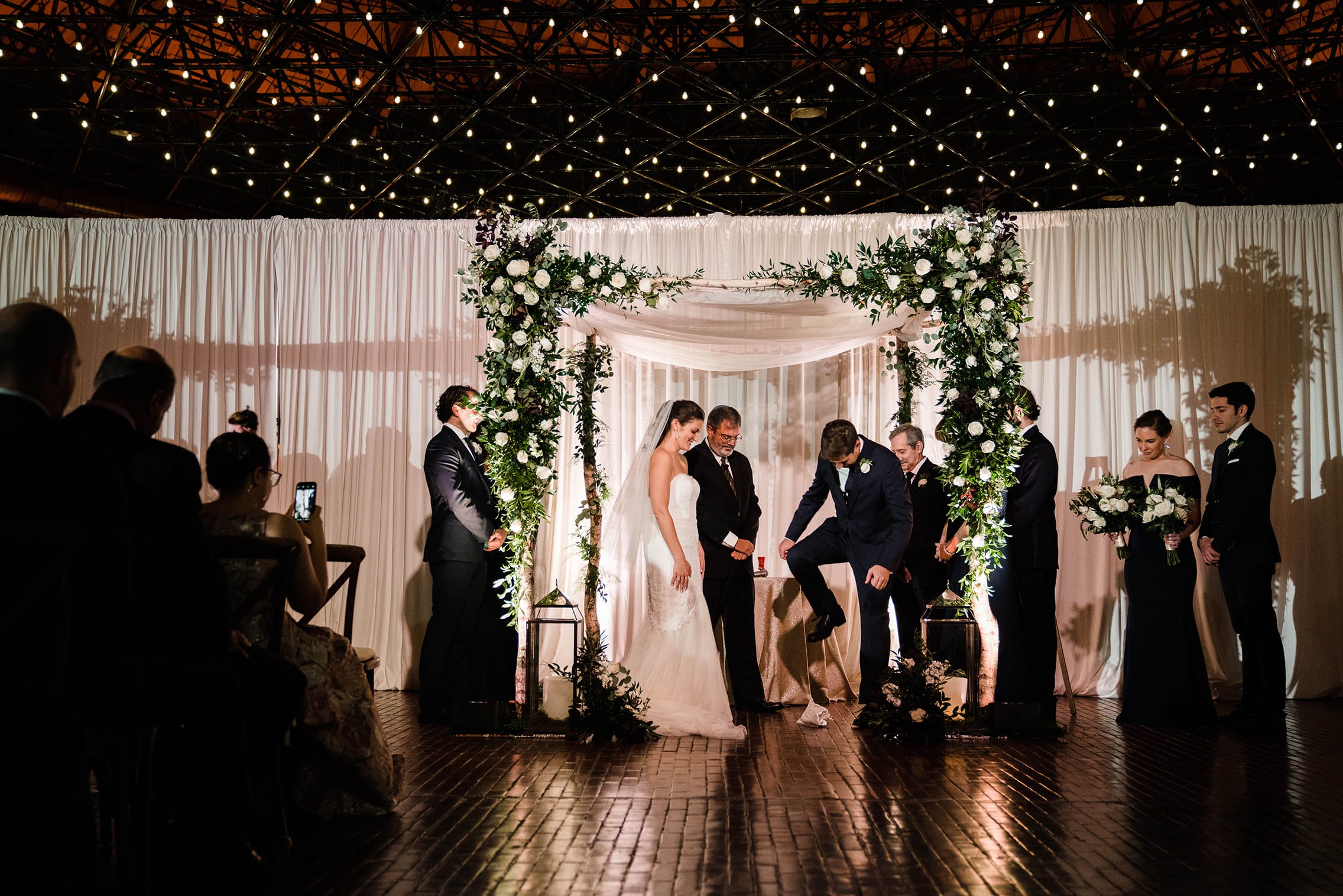 A best of Boston wedding photograph of couple breaking the glass during their Cyclorama wedding ceremony