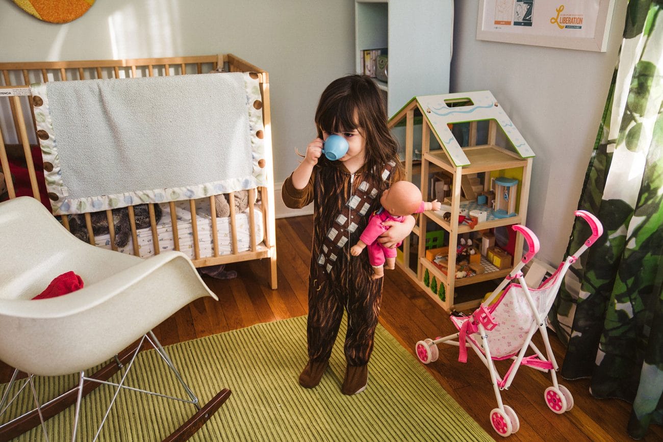 A best of Boston family session of a girl playing in her room during an in home family session in Boston