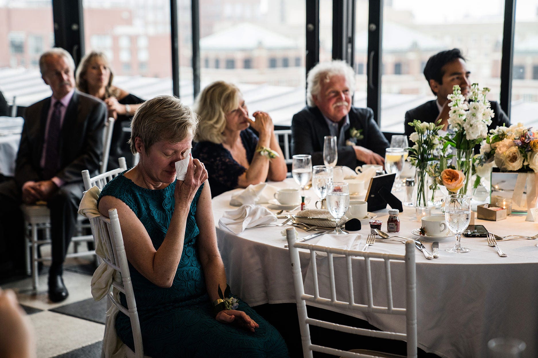 A best of Boston wedding photograph of a mother of bride crying as she dancing with her father during the parent dances at a Taj Boston Rooftop wedding in Boston