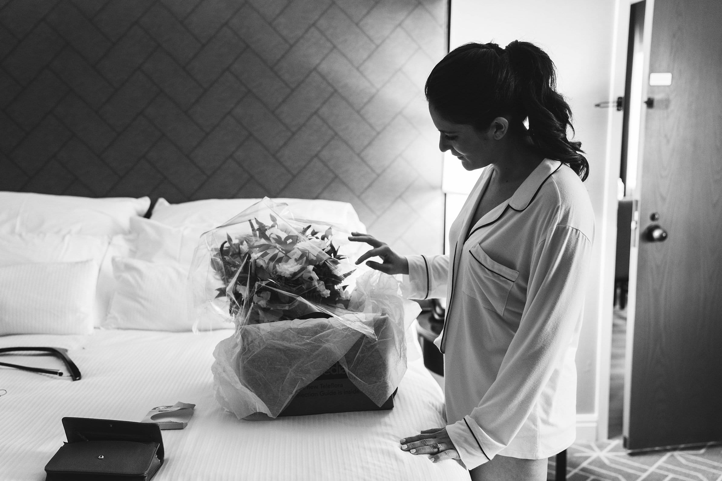 A best of Boston photograph of a bride looking at her wedding bouquet before her Cyclorama wedding in Boston