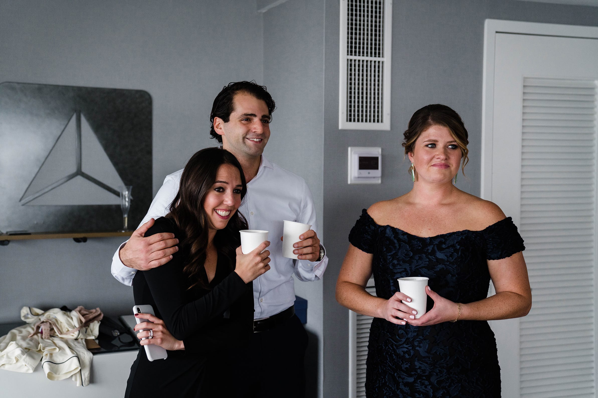 A best of Boston wedding photograph of a bride's brother and friends tearing up as they see her in her wedding dress before her Cyclorama wedding in Boston
