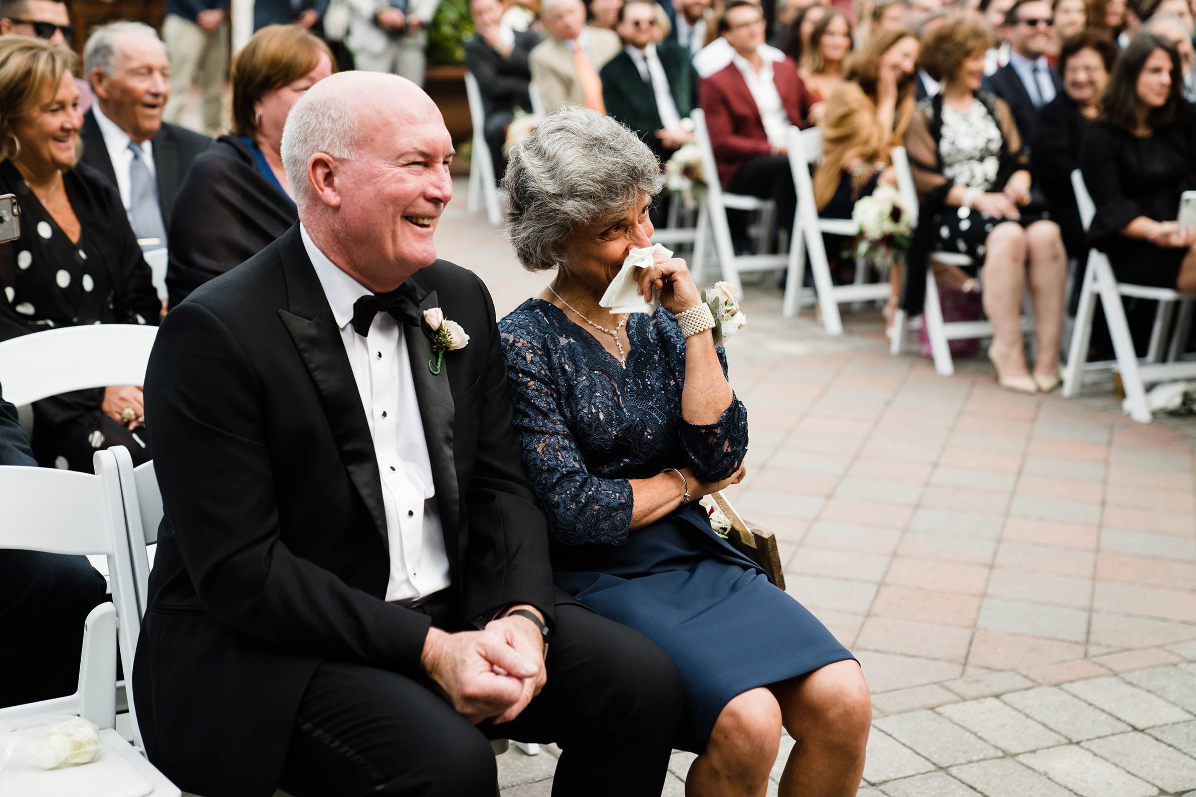 A best of Boston wedding photograph of the mother of the groom crying during a Willowdale estate wedding ceremony